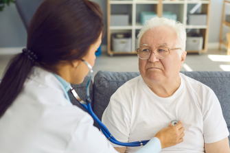 Healthcare professional checking a community member’s blood pressure