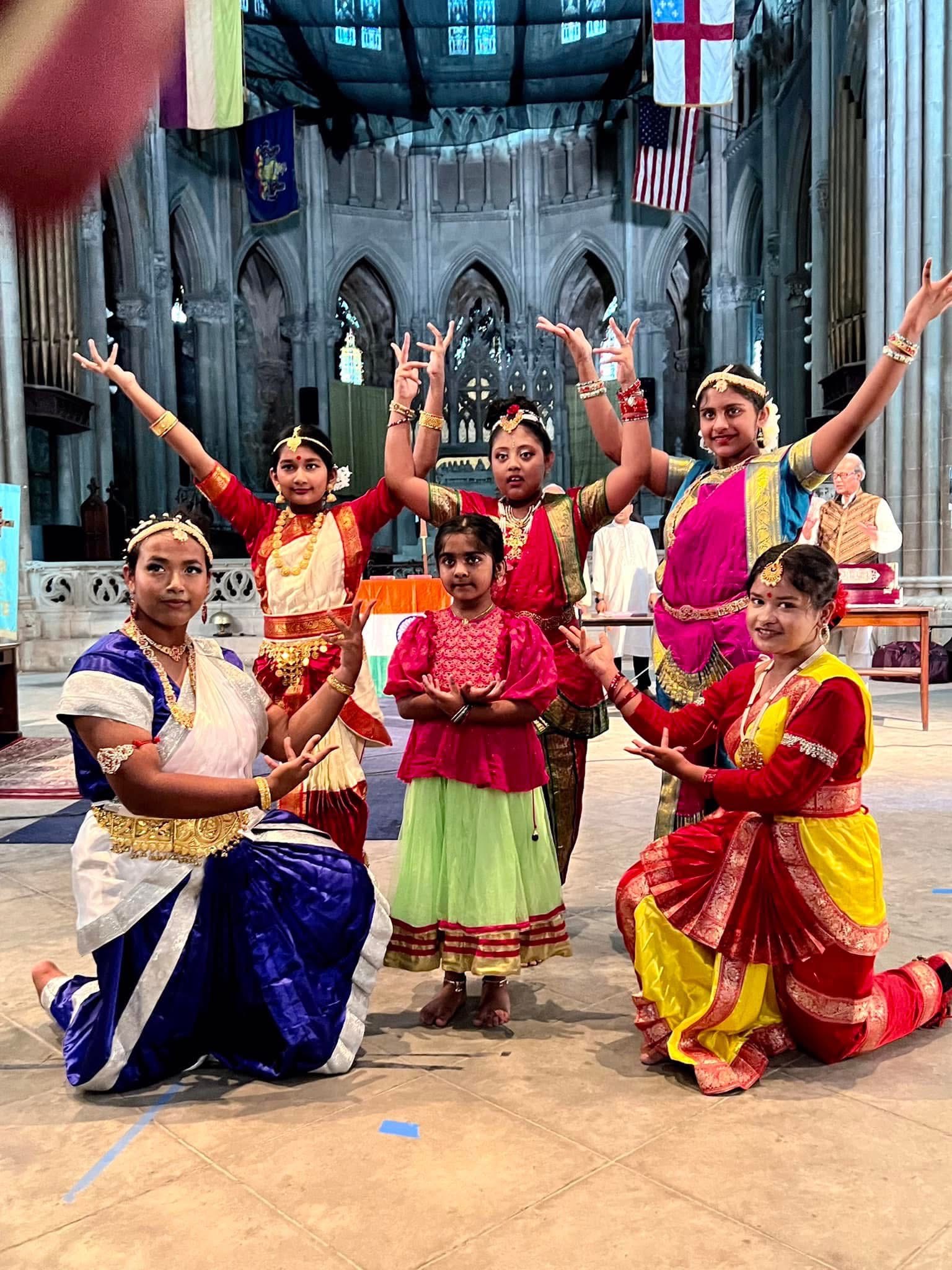 Young Shaptak Sangeet Niketan performers posing in colorful Bengali dance attire